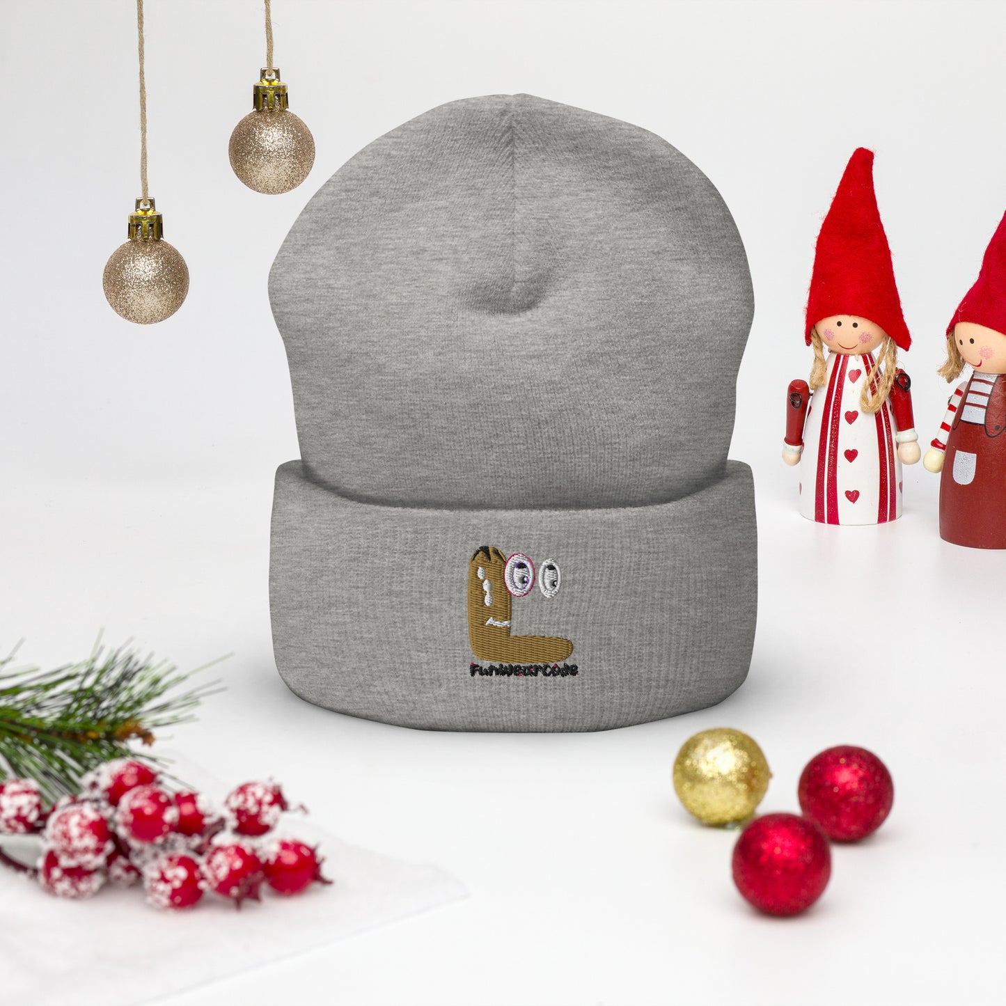 Gray beanie with embroidered design on a white background with Christmas decorations
