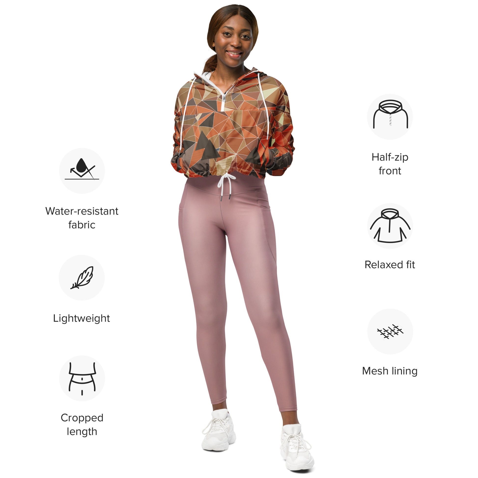 Woman wearing a cropped multicolor geometric patterned windbreaker jacket and pink leggings with feature icons on a white background