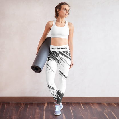 Woman holding a yoga mat wearing a white sports bra and black and white leggings with a brand logo 'Funwearcode'.