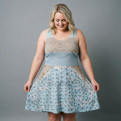 Woman wearing a patterned dress against a gray background