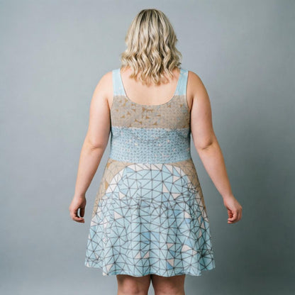 Woman wearing a sleeveless dress with geometric pattern on a gray background