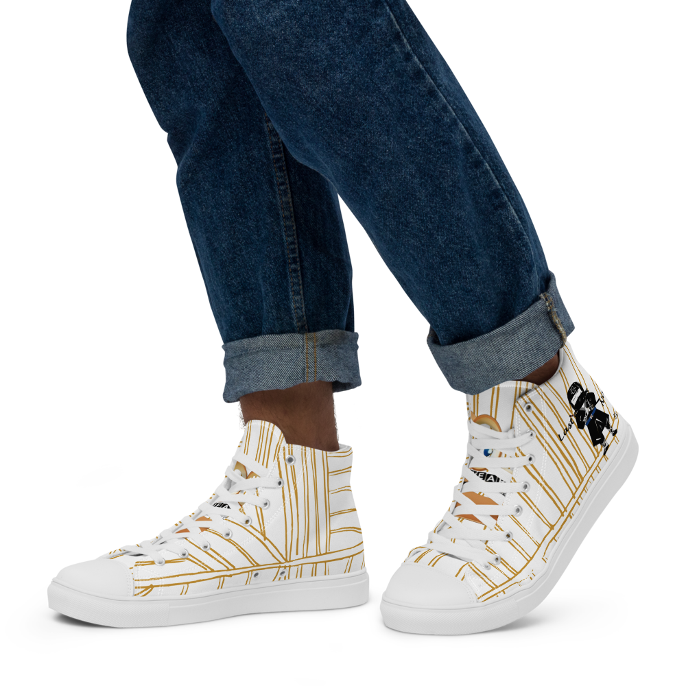 White yellow stripe high-top  sneakers with a playful ninja graphic design and white laces, featuring a text 'Last ninja' worn with blue jeans on a white background