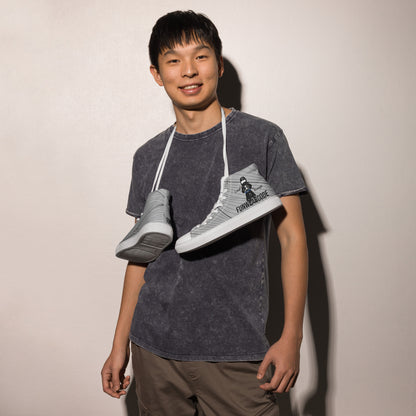 Person holding two sneakers with a ninja graphic and 'Fun Wear Code' text logo against a plain background